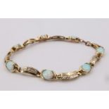 A contemporary faux opal and 9 ct yellow metal bracelet, comprising seven oval opal cabochons each