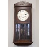 A 1930s oak wall clock, 77 cm