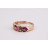 An early 20th Century three stone and pearl 9 ct yellow metal ring, having three pink brilliants (