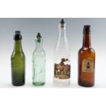 Four vintage glass drinks bottles comprising "Tizer", "J.M. Todd", "Machesons" and "W Lindsay",