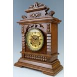 A late 19th Century Ansonia oak mantle clock, having a two train movement striking on a gong, 32