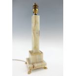 A columnar onyx table lamp on gilt metal claw feet, 37 cm