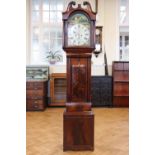 An early 19th Century mahogany long case clock, having an 8-day movement and painted arched face,