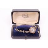 A cased George VI 9 ct gold wristlet watch, having a 15 jewel movement, in a gold case on a rolled