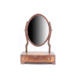 A George III Sheraton style string inlaid and cross-banded mahogany swivel toilet mirror, its bow