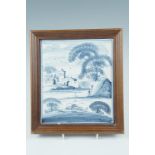 A framed Delft blue and white tile, 24.5 x 22 cm overall