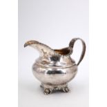 A Victorian Newcastle silver milk jug, of helmet form having a compressed oviform body with
