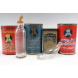 A quantity of vintage baby packaging including "Cow & Gate" milk-food tins together with a glass "