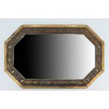 A 1930s embossed brass framed mirror, having canted corners and bevelled glass, 31 x 48.5 cm