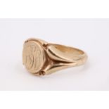 A 9 ct gold signet ring, the matrix having an engraved monogram, between adorsed forked shoulders,