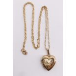 A 1960s 9 ct gold locket necklace, the heart shaped locket having bright cut engraved front, on a