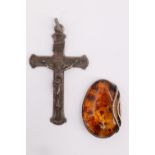 A late 20th Century silver mounted amber brooch, and an early 20th Century white metal crucifix