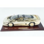 A Goldshield Collectables gold Jaguar XJ220 diecast model car