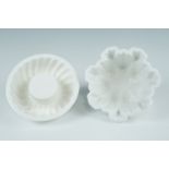 Two late Victorian ceramic jelly moulds, one having an impress mark for Copeland, both 16.5 cm