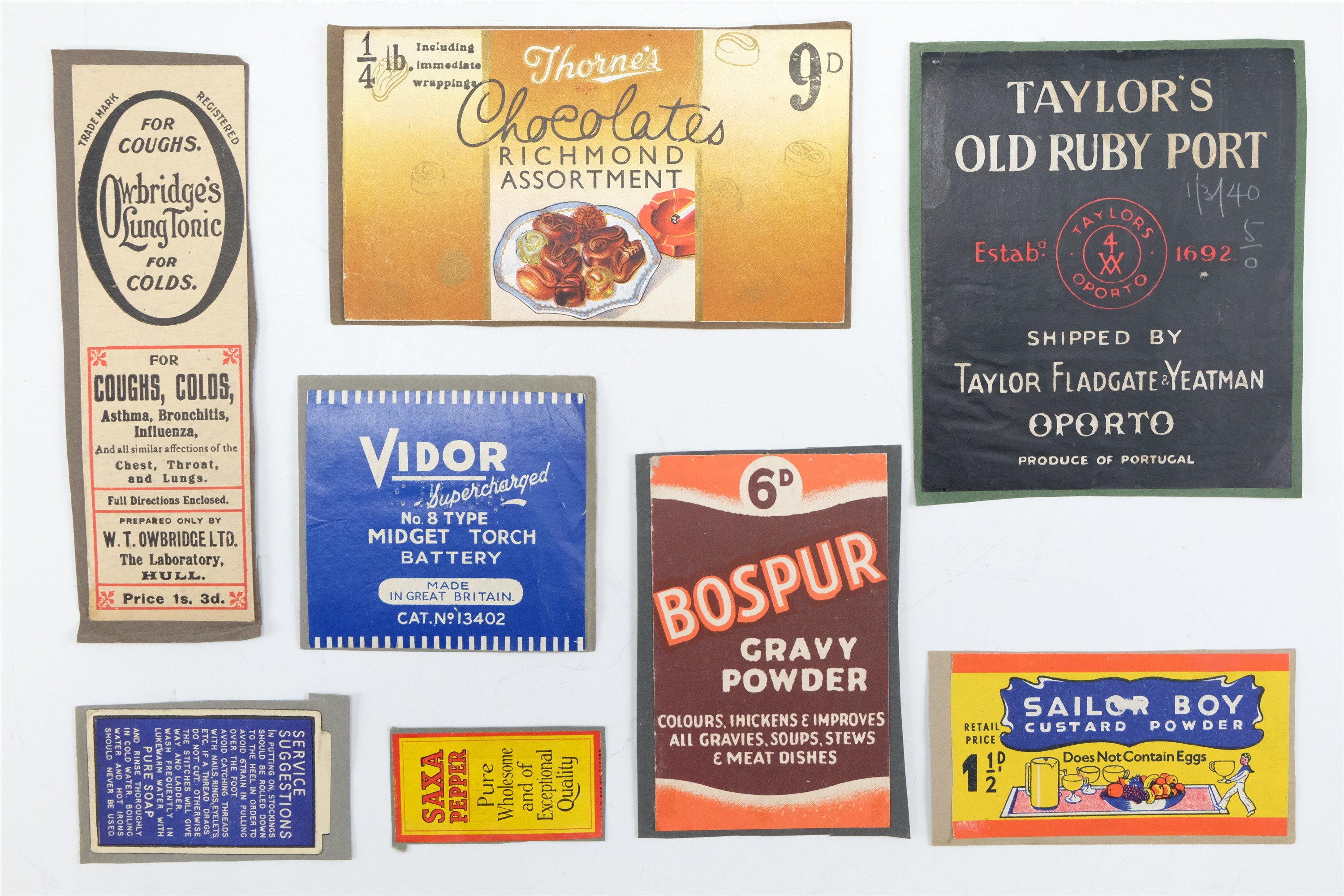 Eight vintage merchandising labels affixed to card including "Taylor's Old Ruby Port" and "Sailor