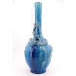 A Victorian aesthetic period blue faience earthenware majolica dragon vase, Burmantofts style,