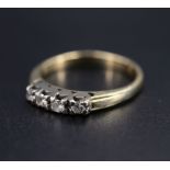 A vintage four stone diamond and yellow metal ring, having four 2 mm brilliants line set in a