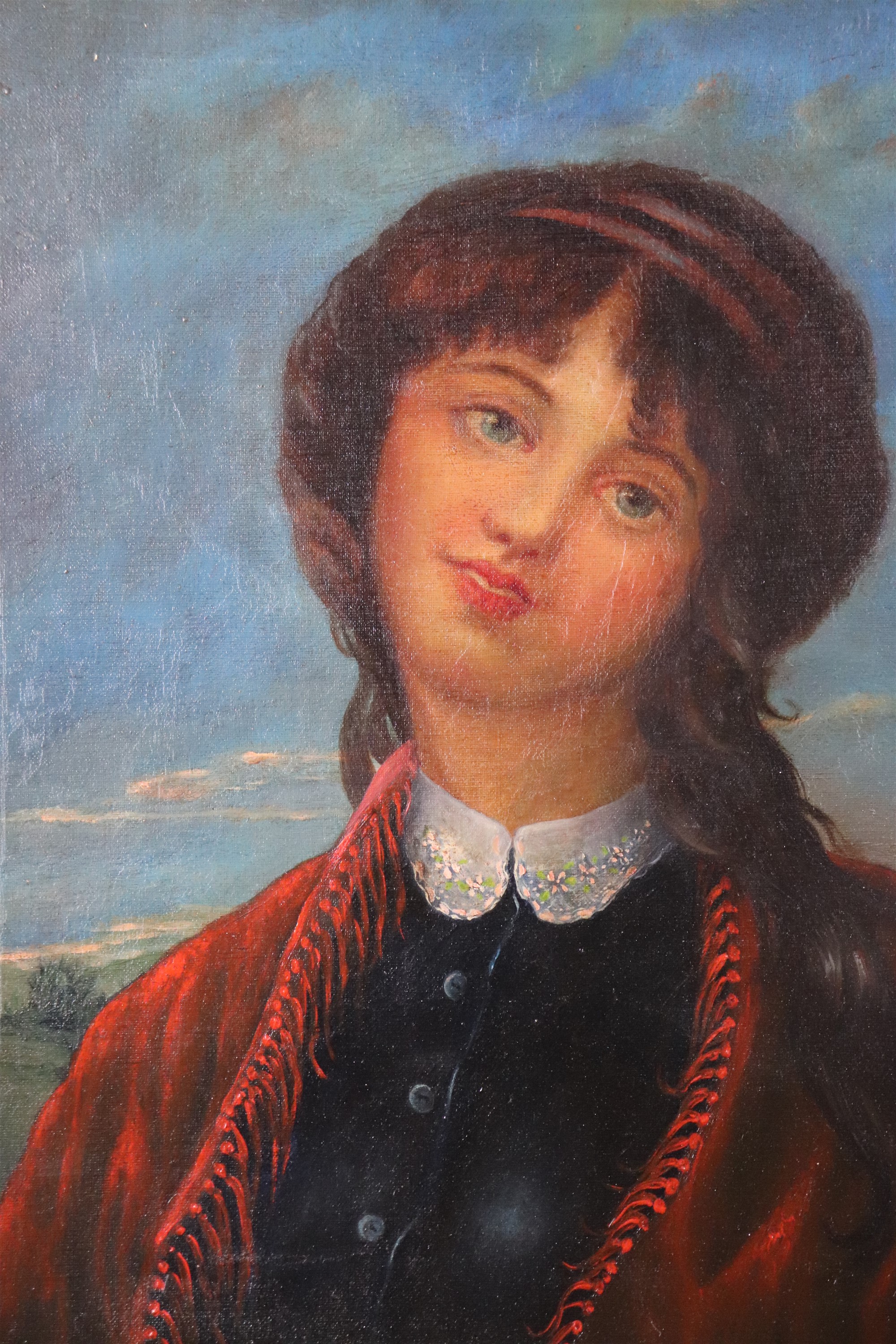 A naive, romantic portrait of a young woman wearing a red tasseled shawl, oil on canvas, late