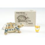 A Wade "Tortoise", in original carton, containing Dubarry "Gardenier" perfume, 9.5 cm