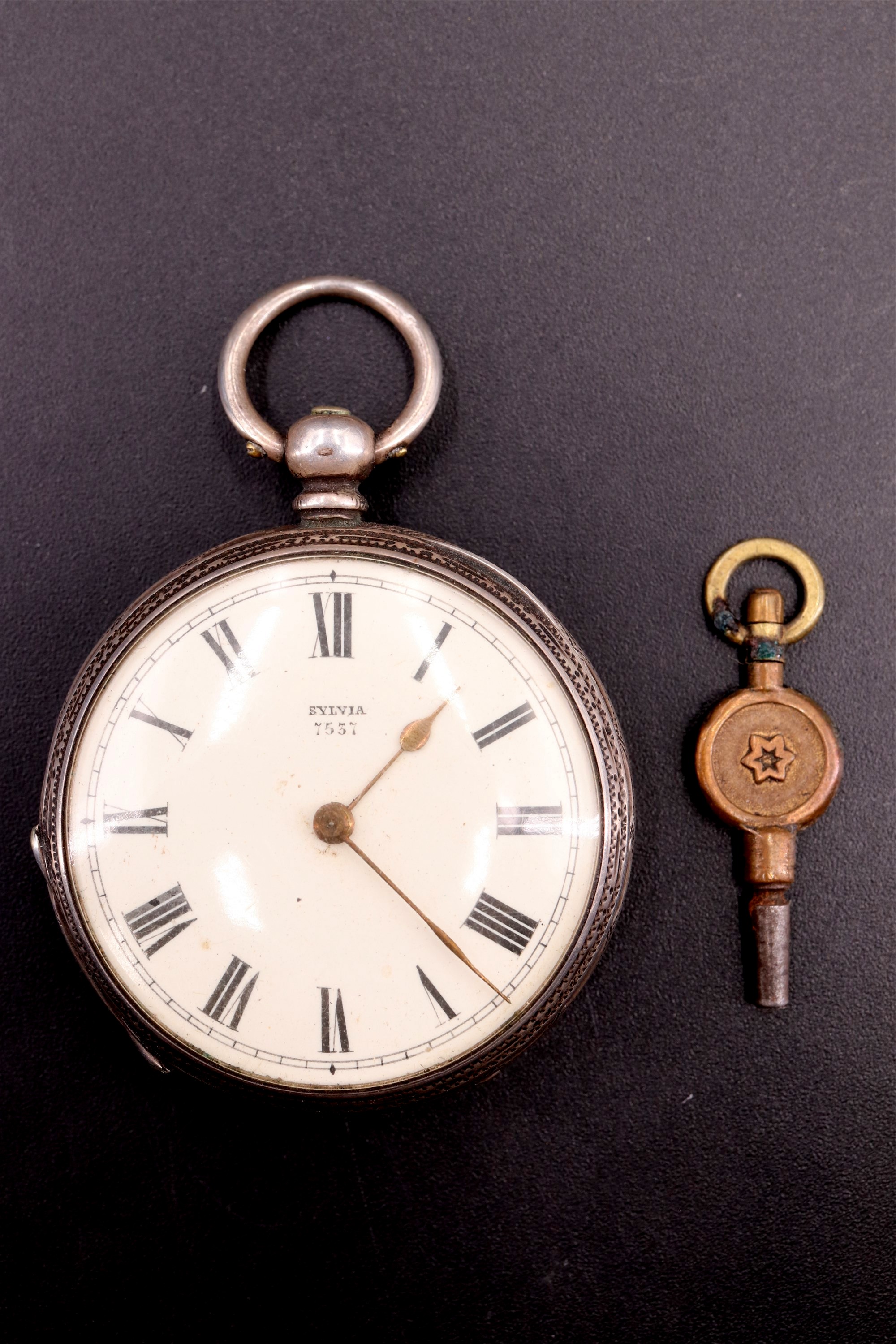 A late 19th Century Swiss white metal fob watch, having a key wind and set movement, a white