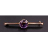 A vintage amethyst and 9 ct yellow metal bar brooch, having a 9 mm brilliant set in a fine gallery