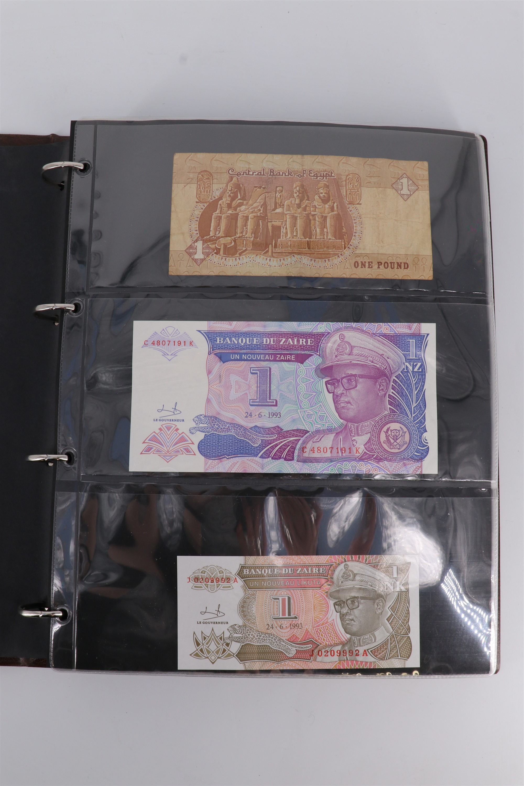 An album containing a collection of world banknotes, including Zaire (DR Congo), Ireland, - Image 2 of 87