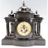 A Victorian black marble mantle clock, having a French drum movement by Mougin and striking on a