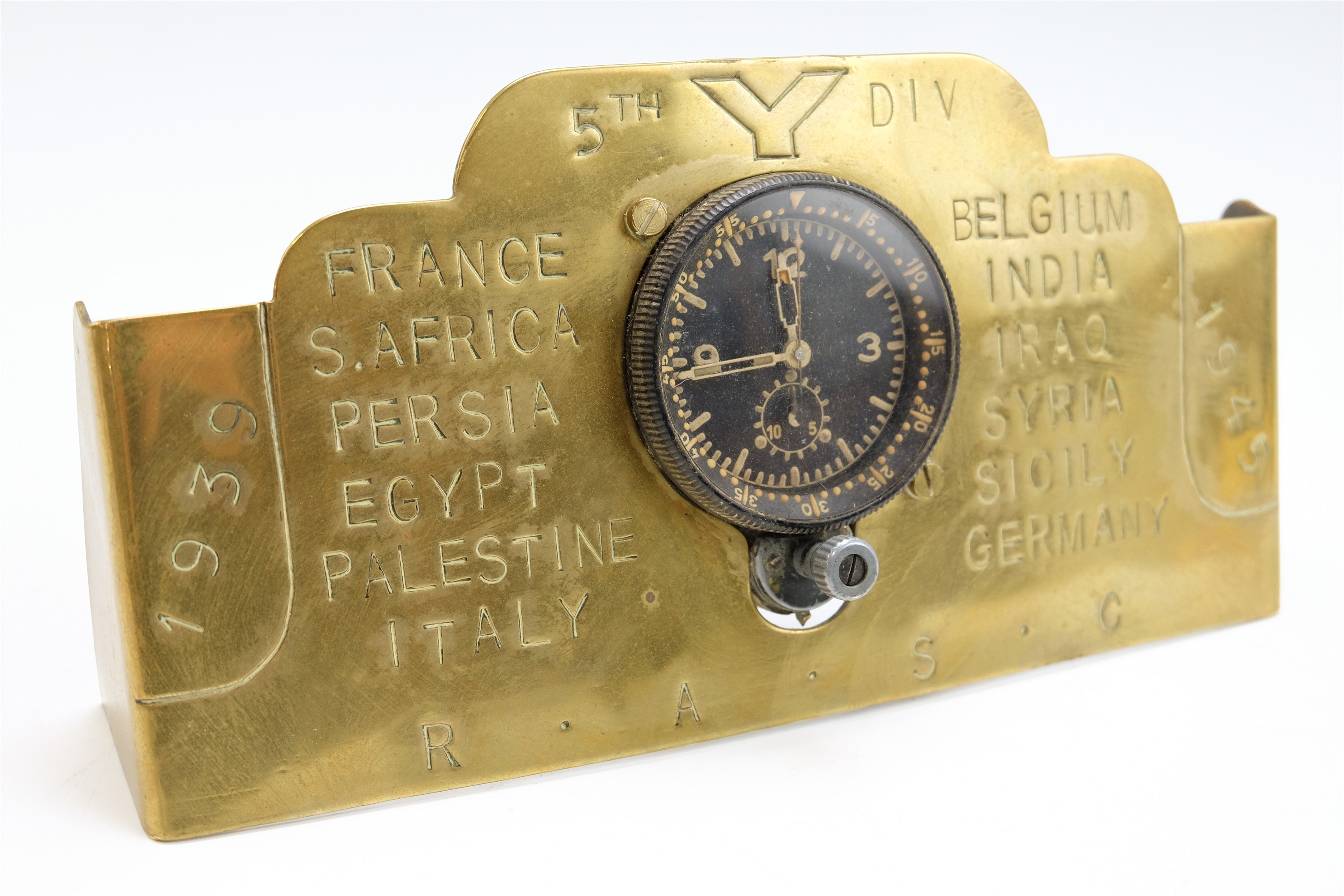 A German Third Reich Luftwaffe aircraft cockpit clock, mounted onto a brass stand by a Royal Army
