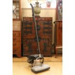 An early Hoover upright vacuum cleaner, bearing plaque "It Beats, While it Sweeps, While it