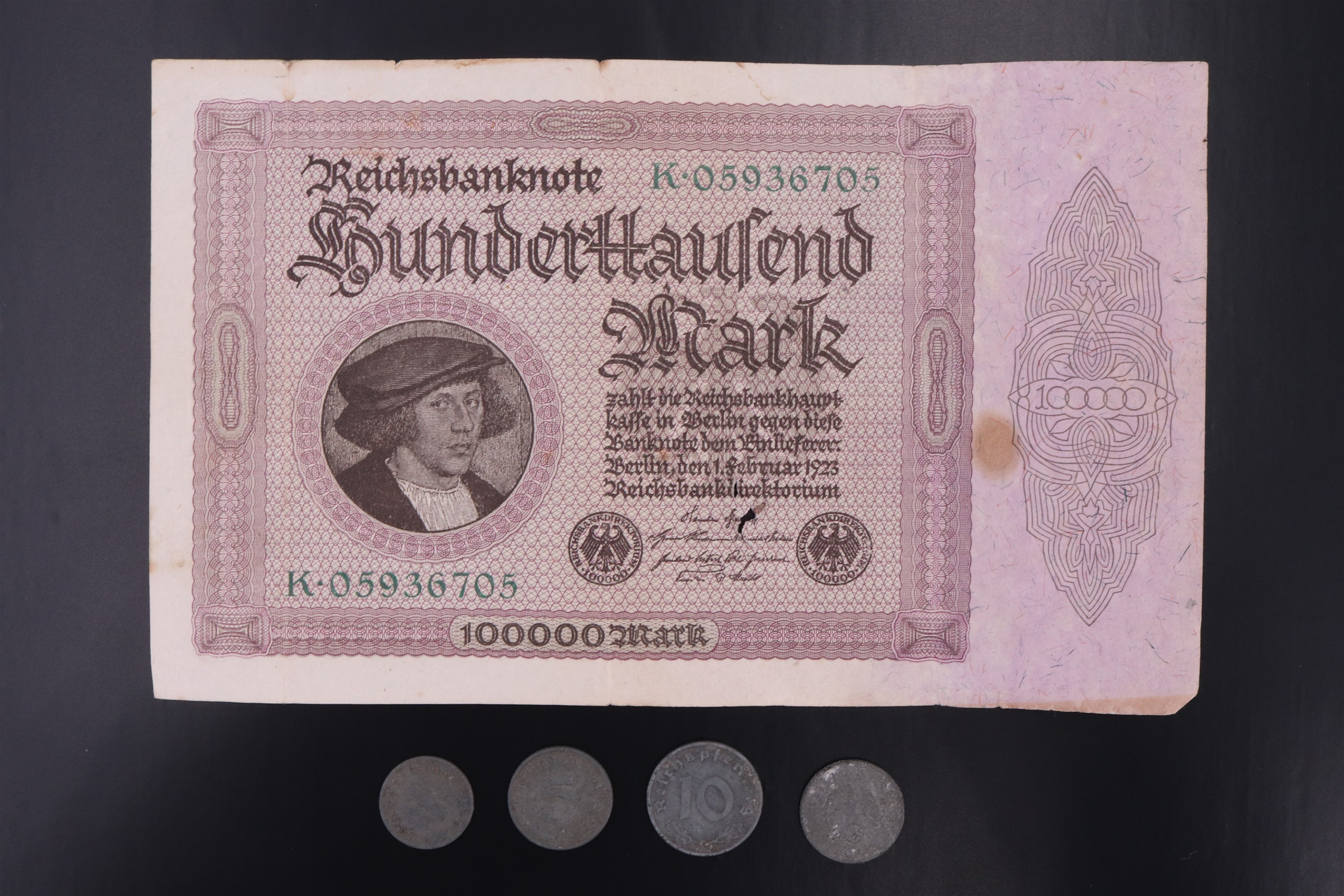 A Weimar German hyper-inflation banknote together with four German Third Reich coins