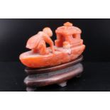A Chinese carved agate fisherman and boat, on wooden stand, 72 mm