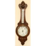 An early 20th Century Comitti of London carved oak banjo aneroid barometer, 88 cm