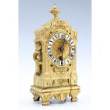 A late 19th Century French gilt metal baroque style boudoir pendulum clock, with key, 21 cm