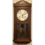 A 1930s oak wall clock, 77 cm