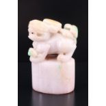 A Chinese carved jade seal, its top in the form of a guardian lion, 5 cm