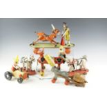 A group of vintage wood and tinplate pull-along toys, including a matador and bull bearing a