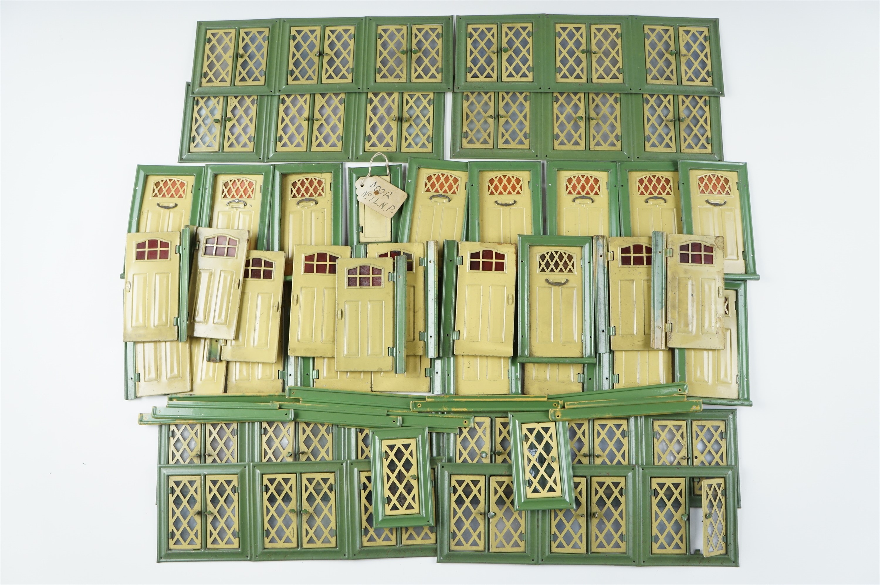 A quantity of tinplate doll's house doors and windows, larger doors 11 x 6.5 cm