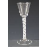 A mid 18th Century wine glass having an opaque double spiral and spiral ribbon twist stem, 16 cm