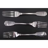 A pair of George VI fiddle pattern silver table forks and another similar, respectively London, 1823