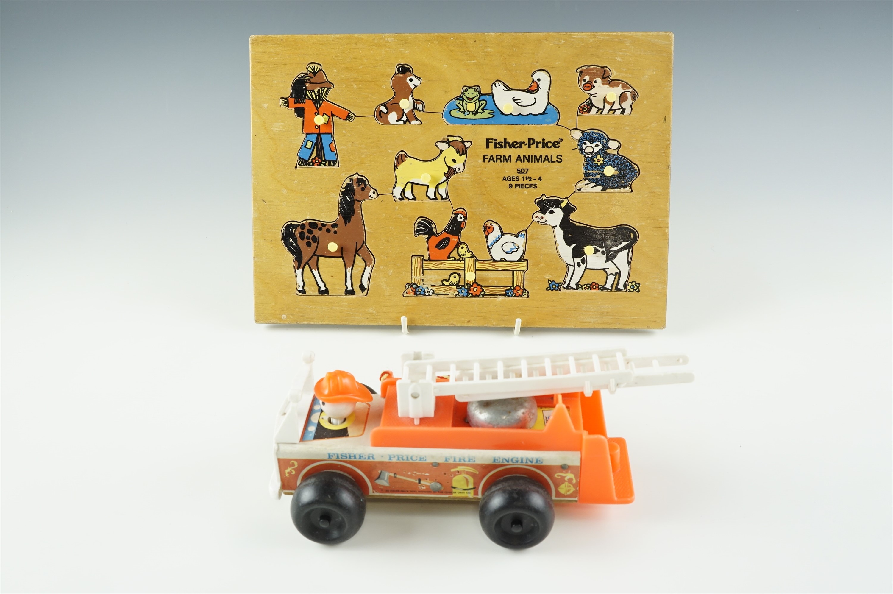 A 1960s Fisher Price fire truck together with a Fisher Price wooden "Farm Animal" puzzle, latter