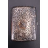 An Edwardian silver cigarette case, having bright cut decoration front and verso, a monogram to