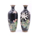 A pair of early 20th Century Japanese cloisonne shouldered oviform vases, decorated in depiction