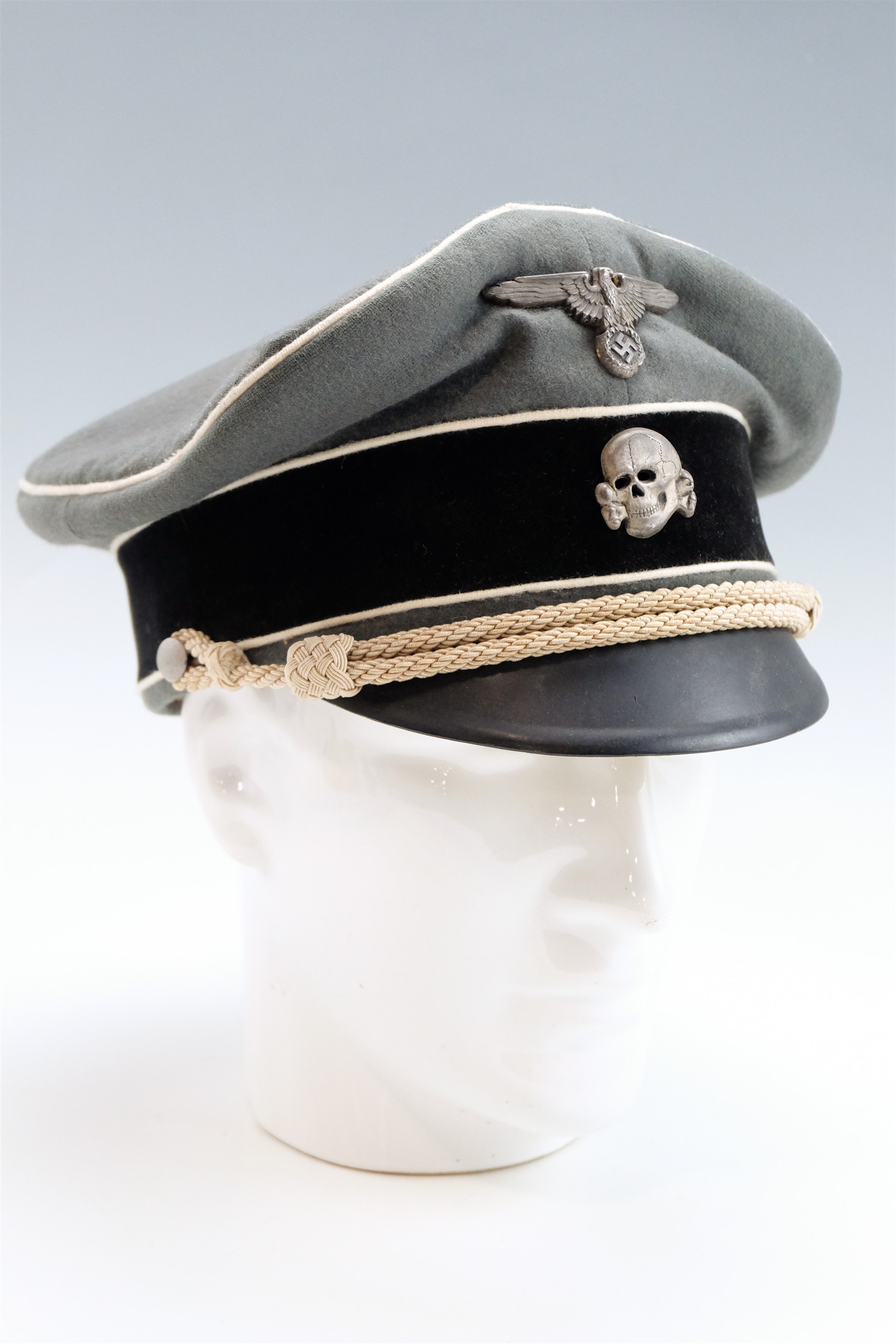 A reproduction German Third Reich Waffen SS officer's peaked cap