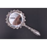 A 1930s / 1940s Portuguese white metal hand held looking glass, of diminutive form having an