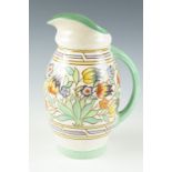 A Charlotte Rhead floral decorated jug, 23 cm