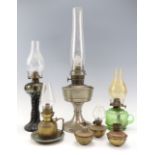 A Super Aladdin oil lamp, 60 cm together with a green glass finger lamp etc