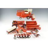 A group of The ERTL Company diecast farm toys, including a combine harvester, a tractor, trailers,