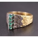 A 1970s French emerald and yellow metal ring, having four 2 mm brilliants transverse set in a line