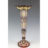 An early 20th Century Bohemian ruby glass vase, of tall slender baluster form, ruby flashed and