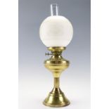 A brass oil lamp with an etched glass globe, 56 cm